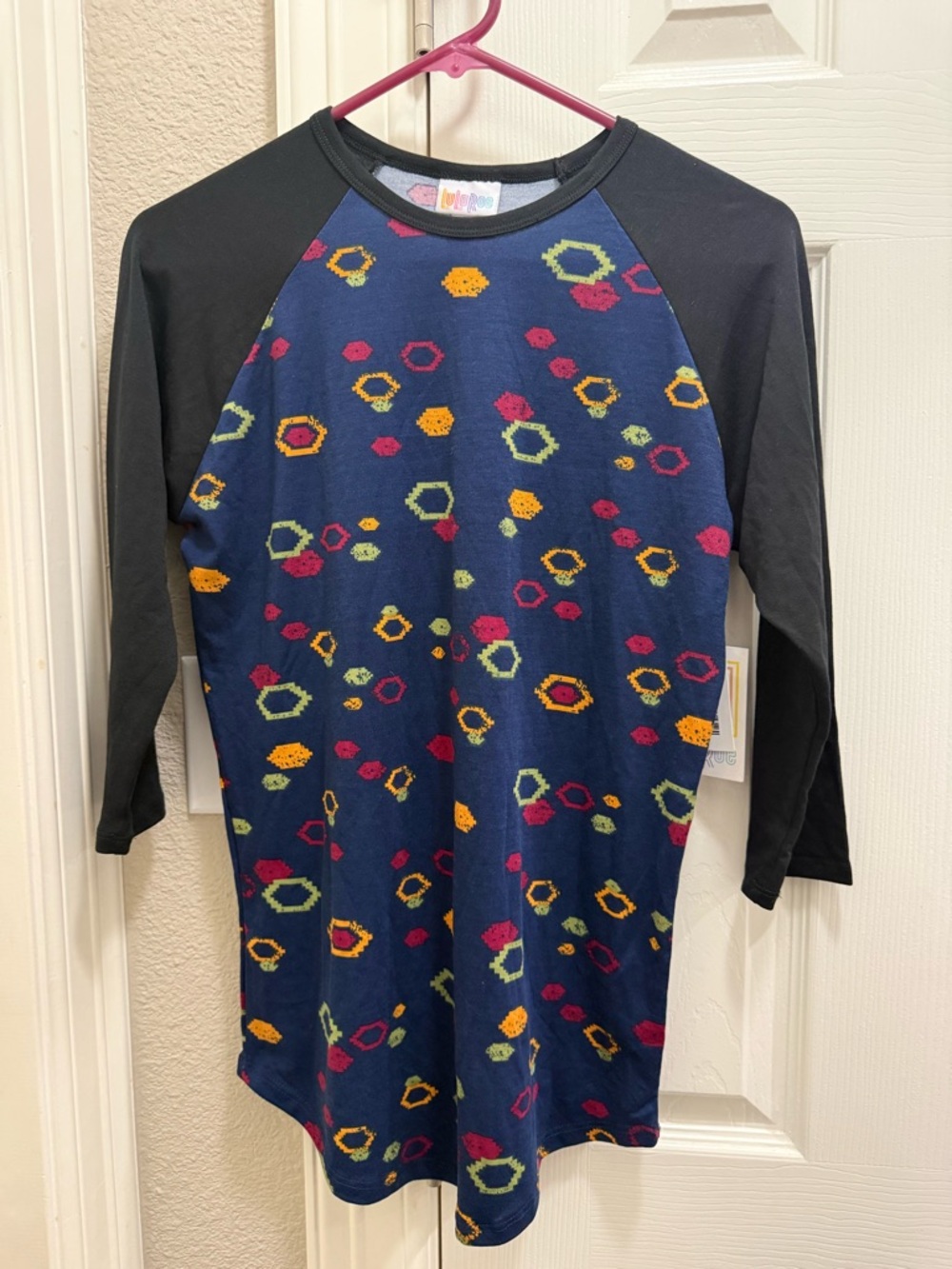 LuLaRoe Navy Blue Randy Top with Black Sleeves and Multi-Colored Hex Print